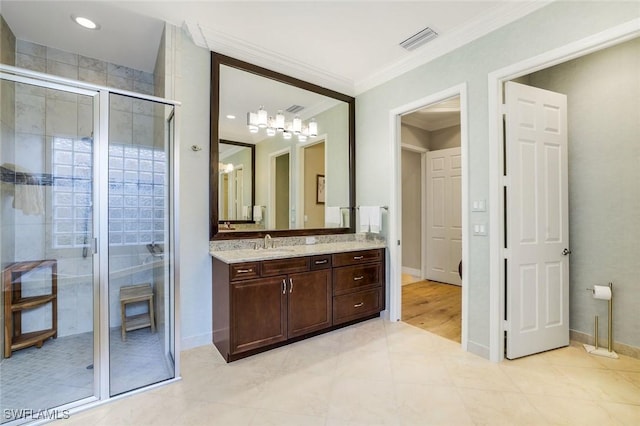 full bathroom featuring visible vents, ornamental molding, a shower stall, vanity, and baseboards