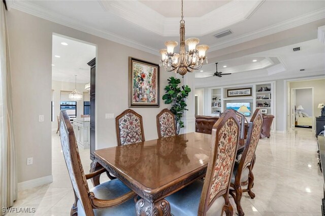 dining area with baseboards, visible vents, built in features, a raised ceiling, and crown molding