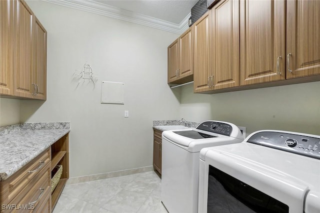 laundry room with cabinet space, ornamental molding, washing machine and dryer, a sink, and baseboards