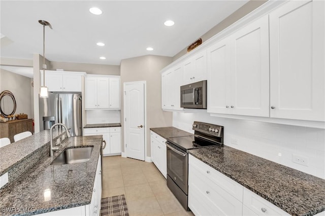 kitchen with white cabinetry, pendant lighting, appliances with stainless steel finishes, and a sink