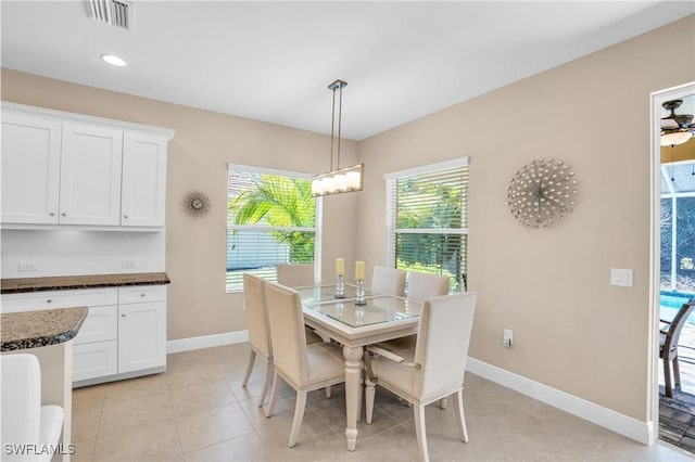 dining space with baseboards, visible vents, light tile patterned flooring, recessed lighting, and a notable chandelier