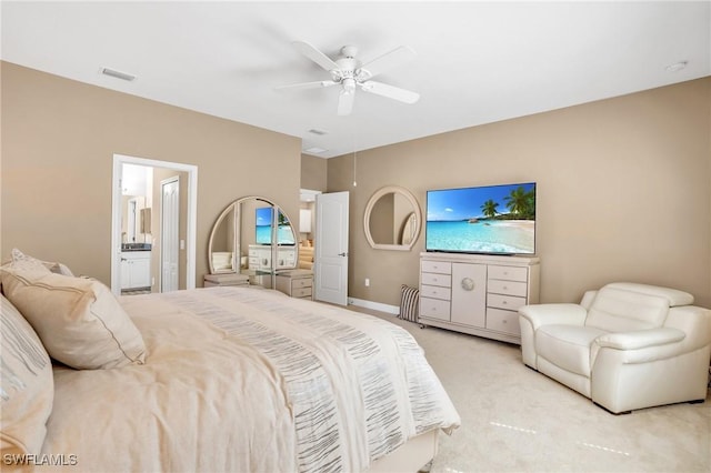 bedroom featuring visible vents, a ceiling fan, connected bathroom, baseboards, and light colored carpet