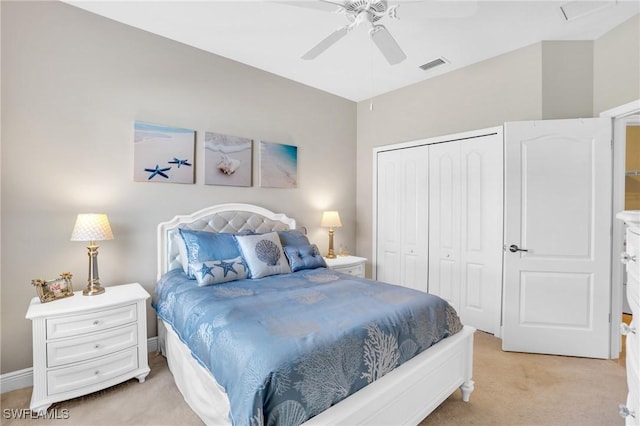 bedroom featuring a closet, visible vents, light colored carpet, and ceiling fan