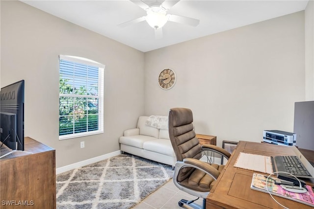 tiled home office featuring baseboards and ceiling fan