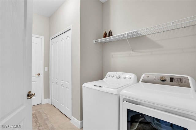 laundry room with washer and dryer, laundry area, and baseboards