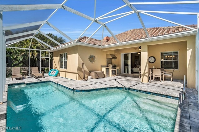 outdoor pool with a ceiling fan, a lanai, outdoor dining space, and a patio area