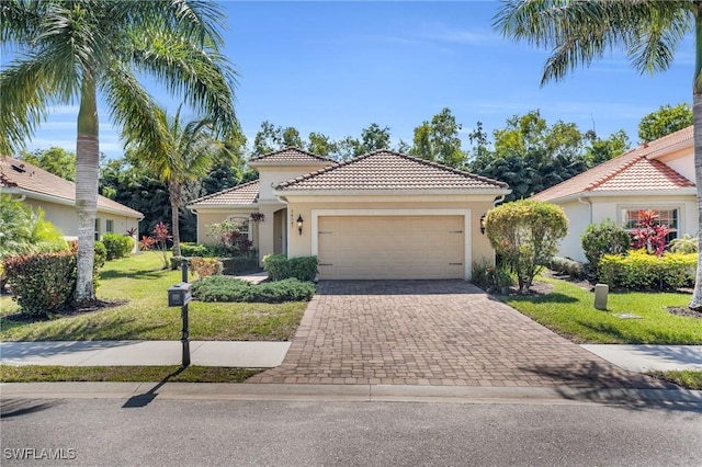 mediterranean / spanish-style home with stucco siding, a front lawn, a tile roof, decorative driveway, and an attached garage