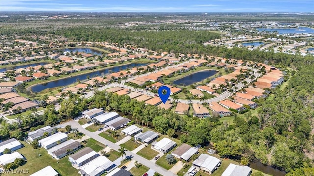 drone / aerial view with a residential view and a water view