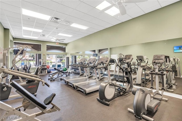 workout area featuring a paneled ceiling and a ceiling fan