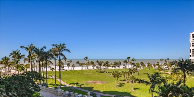 view of property's community with a yard and a water view