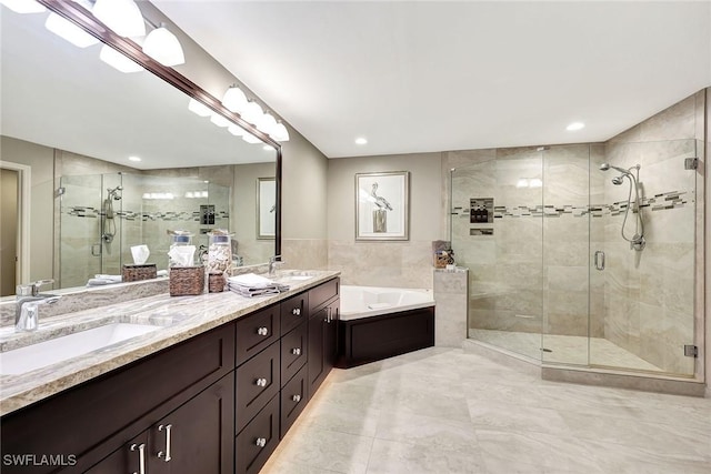 bathroom with double vanity, a sink, a shower stall, and a bath