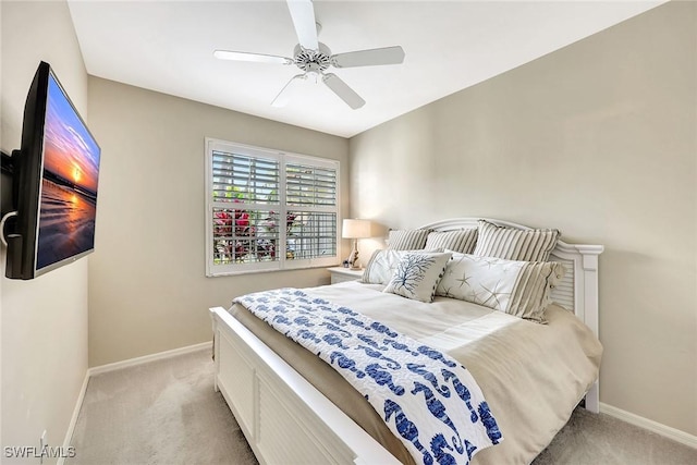 bedroom featuring light carpet, ceiling fan, and baseboards