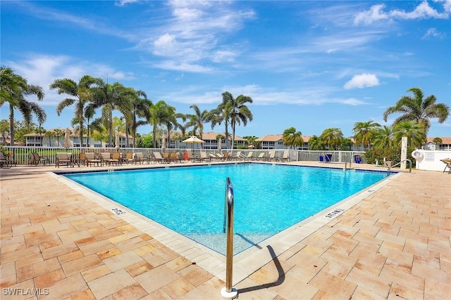 pool with fence and a patio