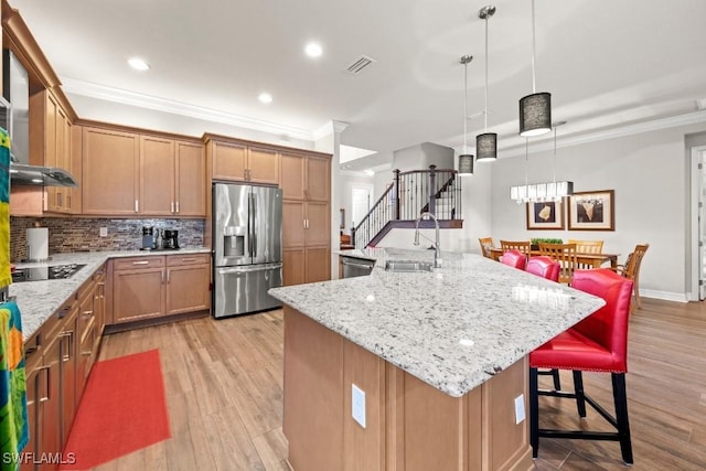 kitchen with visible vents, decorative backsplash, appliances with stainless steel finishes, crown molding, and a sink