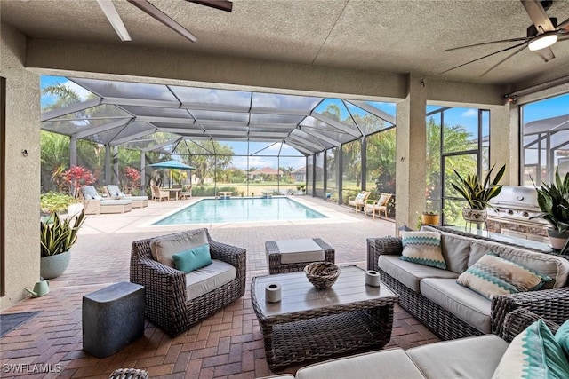 outdoor pool featuring ceiling fan, a lanai, a grill, a patio area, and an outdoor living space