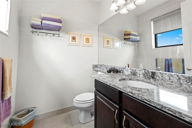 half bath featuring toilet, tile patterned flooring, baseboards, and vanity