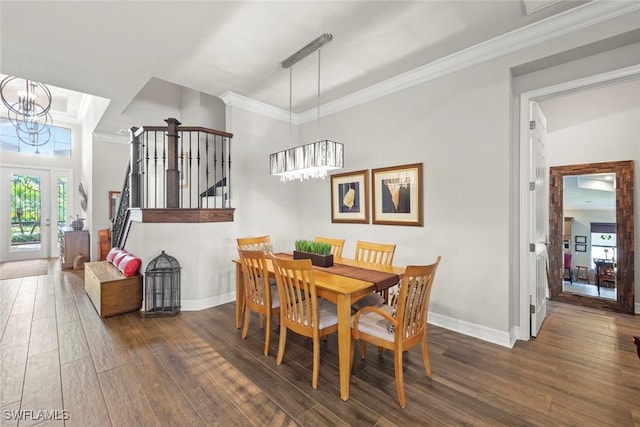 dining space with stairway, ornamental molding, a notable chandelier, and wood finished floors