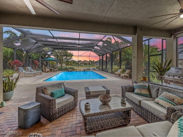 pool featuring a lanai, a patio area, ceiling fan, and an outdoor hangout area