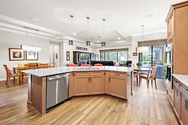 kitchen featuring light wood-style flooring, open floor plan, hanging light fixtures, dishwasher, and crown molding