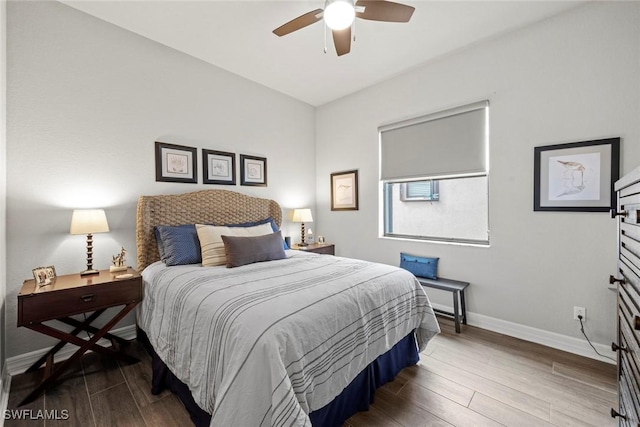 bedroom featuring ceiling fan, baseboards, and wood finished floors