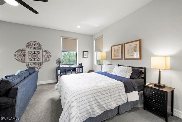 carpeted bedroom with ceiling fan and baseboards