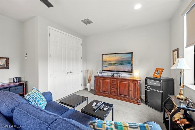 living area featuring light carpet, recessed lighting, visible vents, and baseboards