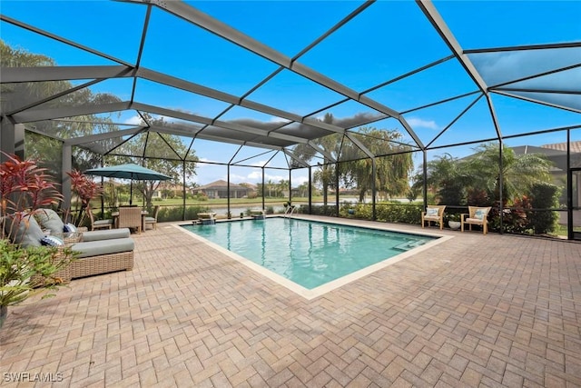 outdoor pool featuring glass enclosure and a patio area