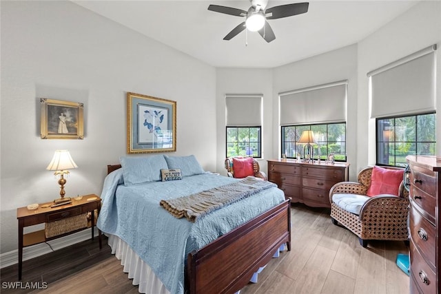 bedroom with a ceiling fan and wood finished floors