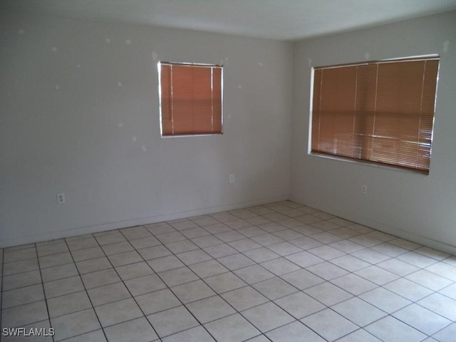 spare room featuring baseboards