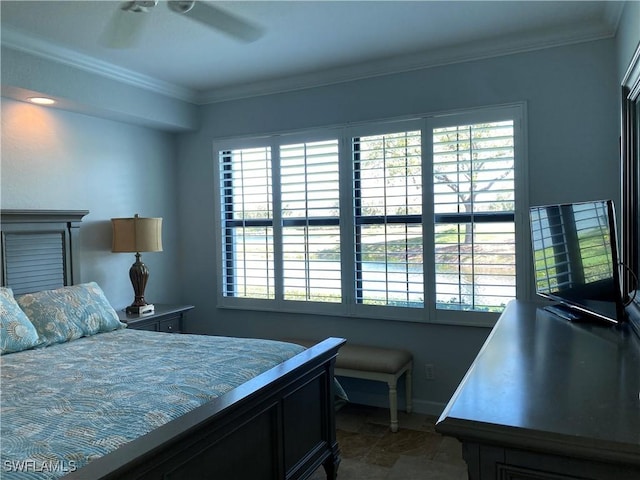 bedroom with stone finish flooring, crown molding, baseboards, and ceiling fan