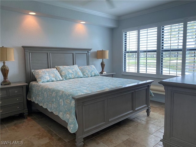 bedroom with stone tile flooring and crown molding