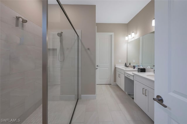 bathroom with double vanity, baseboards, walk in shower, and a sink