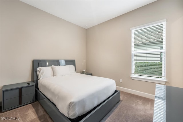 bedroom featuring carpet and baseboards