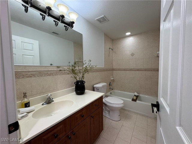 bathroom featuring tile patterned flooring, toilet, visible vents, tile walls, and tub / shower combination