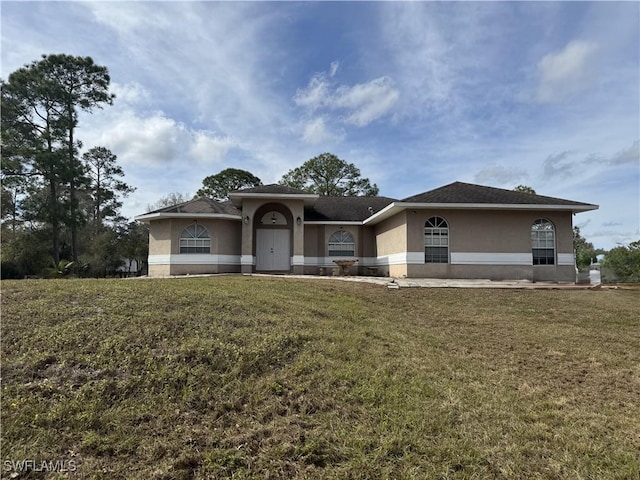 view of front facade with a front lawn and stucco siding