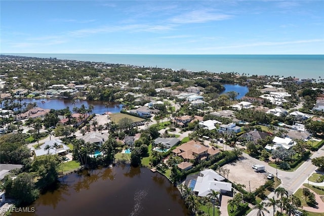 birds eye view of property with a water view and a residential view