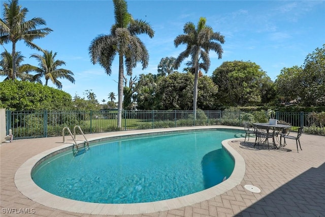 view of swimming pool featuring a fenced in pool, a patio, and fence