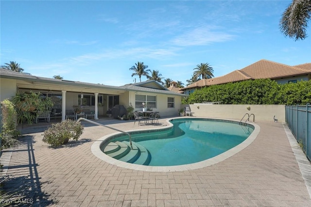 view of pool with a patio, a fenced backyard, and a fenced in pool