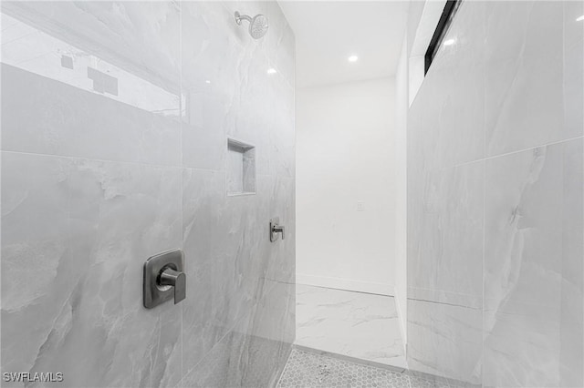 bathroom with baseboards and a marble finish shower