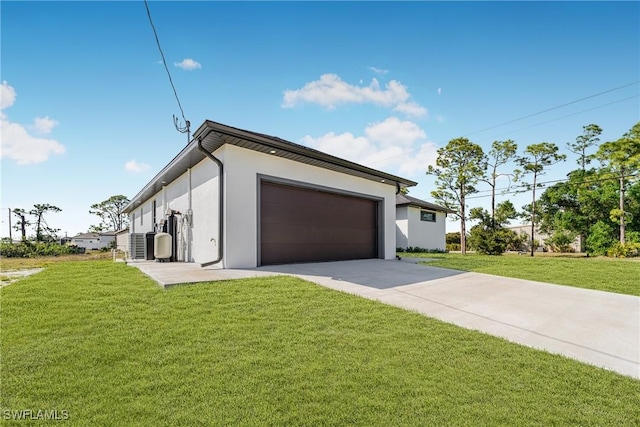 view of side of property with concrete driveway, a yard, an attached garage, and stucco siding