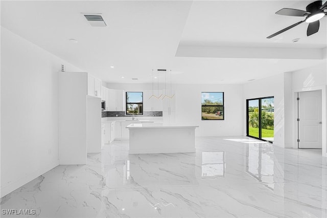 interior space with marble finish floor, recessed lighting, visible vents, a sink, and ceiling fan