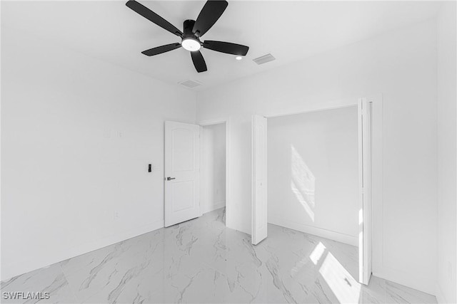 unfurnished bedroom with a ceiling fan, marble finish floor, visible vents, and baseboards