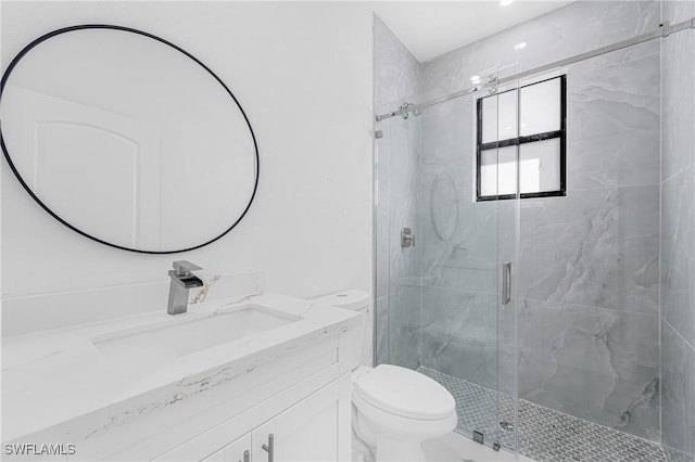 bathroom featuring vanity, a marble finish shower, and toilet