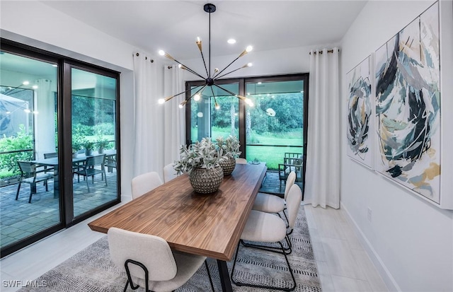 dining space with baseboards and an inviting chandelier