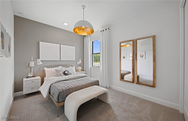 bedroom featuring carpet and baseboards