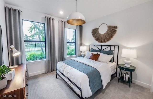 bedroom with recessed lighting, light colored carpet, and baseboards