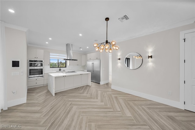 kitchen featuring range hood, stainless steel appliances, light countertops, visible vents, and baseboards