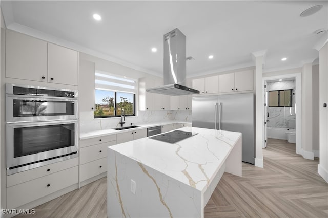 kitchen featuring a center island, backsplash, appliances with stainless steel finishes, a sink, and island range hood