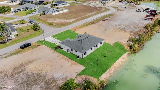 birds eye view of property with a water view and a residential view