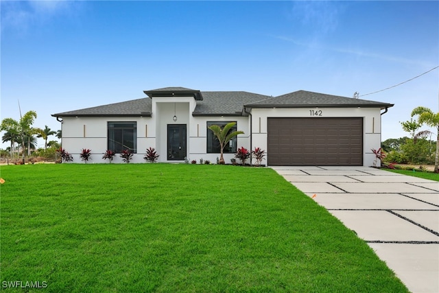 1142 NE 37th St, Cape Coral, FL 33909 - prairie-style house with stucco siding, concrete driveway, a front yard, an attached garage, and roof with shingles